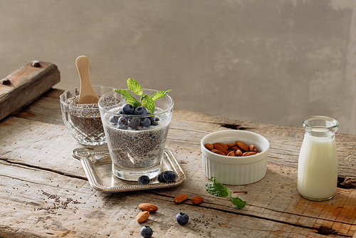 Healthy breakfast or morning snack with chia seeds pudding and berries on wooden rustic background, vegetarian food, diet and health concept