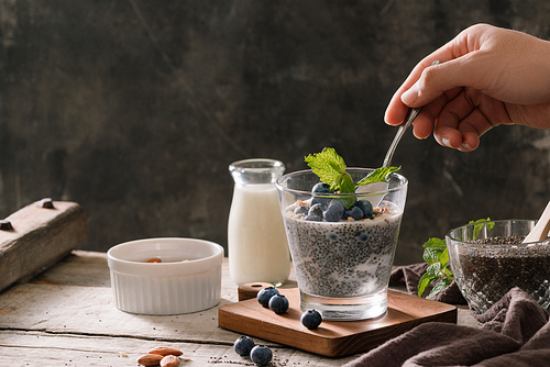 Chia pudding with berries and milk, sweet nourishing dessert, healthy breakfast superfood concept