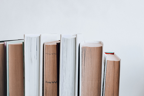 Stack of old book education concept background, many books piles with copy space for text, Book tops, Old and used hardcover books, top view. Educational concept. Close up