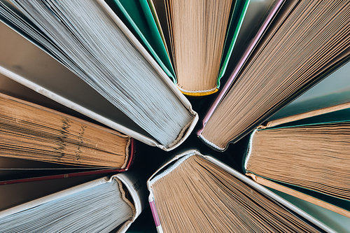 Stack of old book education concept background, many books piles with copy space for text, Book tops, Old and used hardcover books, top view. Educational concept. Close up