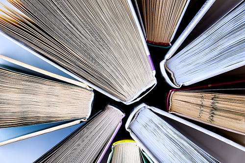 Stack of old book education concept background, many books piles with copy space for text, Book tops, Old and used hardcover books, top view. Educational concept. Close up