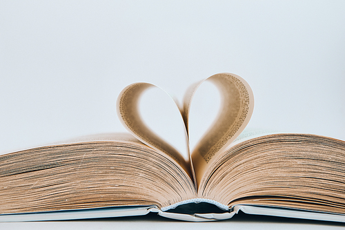 Book with love symbol isolated on white background, Love books, love to read, love stories, heart shape from paper book, Romantic background with the book