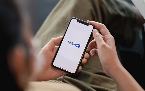 CHIANG MAI, THAILAND - APR 11, 2021: iPhone xs with LinkedIn application on the screen. LinkedIn is a business-oriented social networking service.