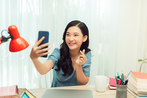 Happy asian girl smiling on video call phone, taking selfie on smartphone,