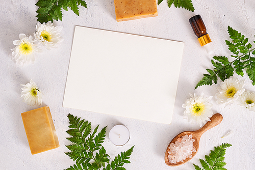 Bathroom salt, soap and aroma oil for spa on white background top view mock-up