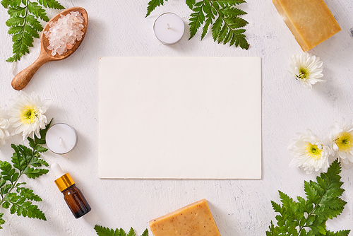 Bathroom salt, soap and aroma oil for spa on white background top view mock-up