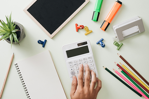 Office workplace - empty notepad, pen, pencil, ruler, compass on dark wooden background