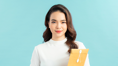 Portrait of a smiling young office worker  holding folders of paperwork
