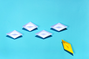 Leadership concept. Yellow paper ship leading among white
