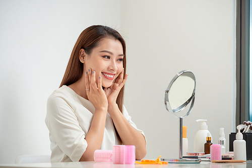 face of young beautiful healthy woman looking in the mirror