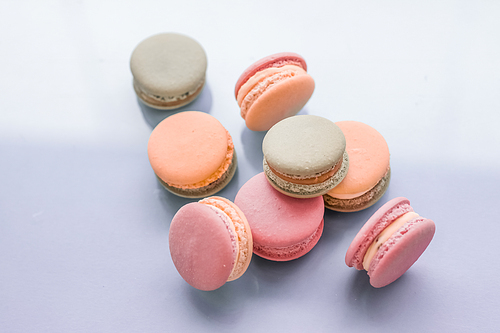 Pastry, bakery and branding concept - French macaroons on blue background, parisian chic cafe dessert, sweet food and cake macaron for luxury confectionery brand, holiday backdrop design