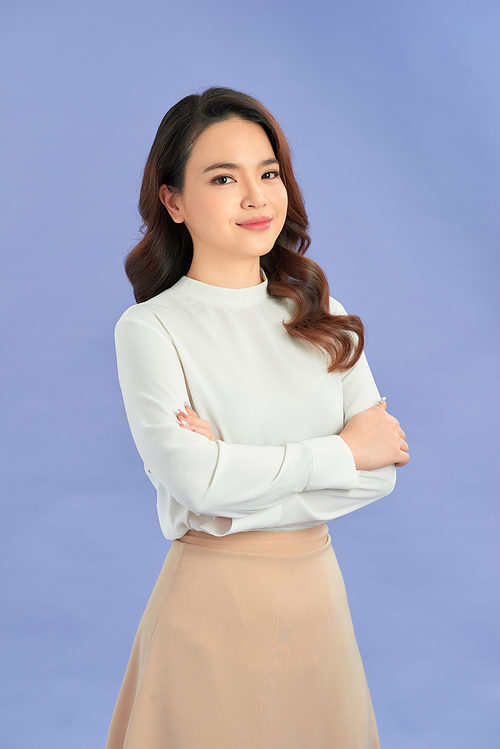 Portrait of successful business asian women with arms crossed and smile isolated over purple background