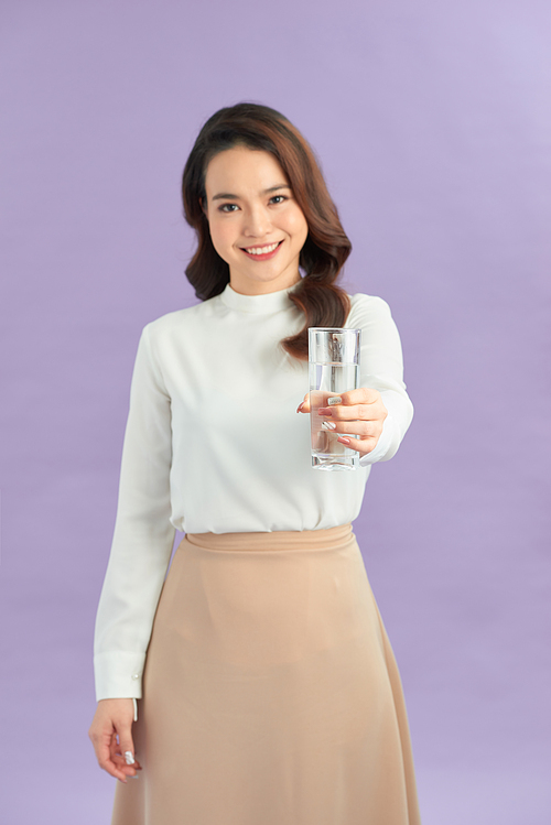 Young smiling woman holding water glass.