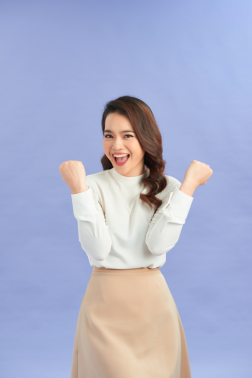 Young woman over isolated purple background celebrating a victory in winner position