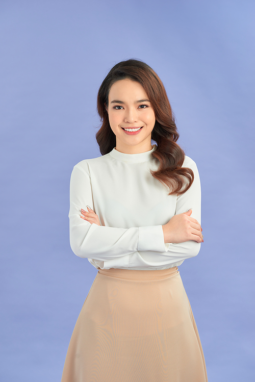 Portrait of successful business asian women with arms crossed and smile isolated over purple background