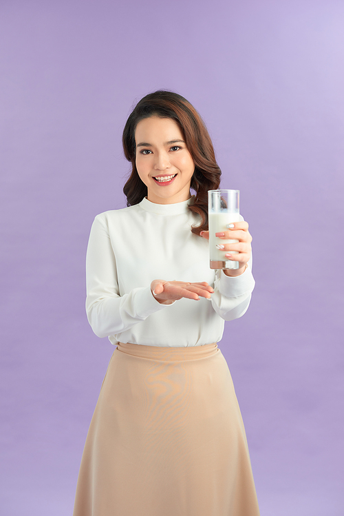 Wellness beauty woman holding a glass of milk in her hand