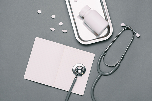 Top view of doctor desk table with stethoscope and medical items. Flat lay.