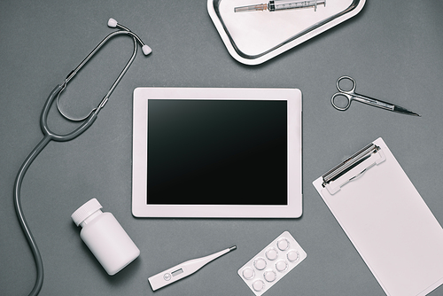 Top view of doctor desk table with stethoscope and medical items. Flat lay.