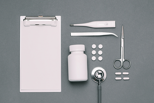 Top view of doctor desk table with stethoscope and medical items. Flat lay.