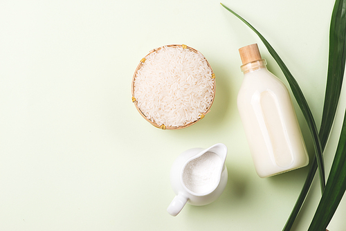 The water that clean out rice like milk in the glass bottle and Some rough rice