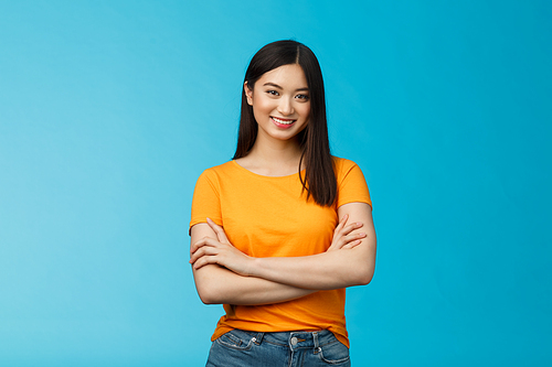 Confident assertive good-looking asian girl with dark short hairstyle cross arms chest self-assured, ready help give advice friendly smiling camera, stand blue background upbeat motivated.