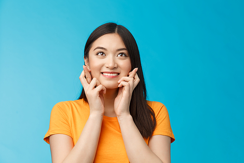 Hopeful excited cute optimistic asian girl believe dreams come true, cross fingers good luck, look up smiling, praying, making wish to win achieve success, student hoping receive scholarship.