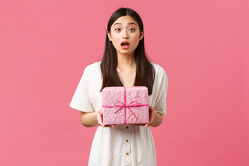 Celebration, party holidays and fun concept. Surprised and touched happy asian girl open mouth in amazement as receive unexpected gift, looking camera grateful, holding box of present.