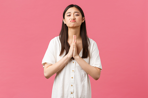 Beauty, people emotions and summer leisure concept. Cute and needy hopeful asian girlfriend asking for favour, pleading with pouting pitiful face, apologizing or saying please, pink background.