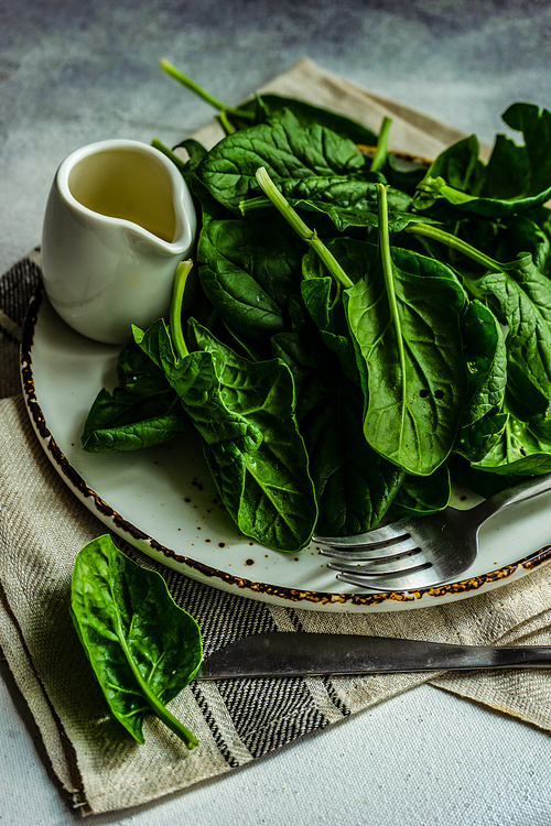 Organic food concept with fresh baby spinach leaves for healthy salad cooking