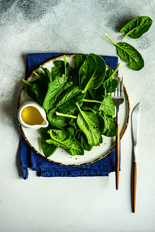 Organic food concept with fresh baby spinach leaves for healthy salad cooking