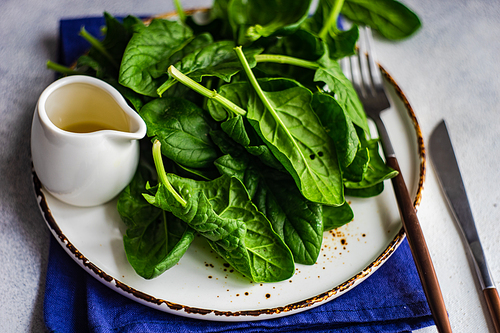 Organic food concept with fresh baby spinach leaves for healthy salad cooking