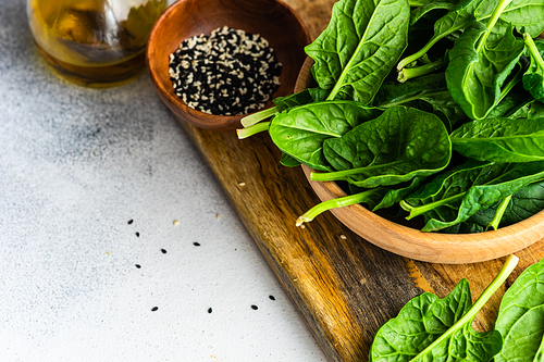 Organic food concept with fresh baby spinach leaves for healthy salad cooking