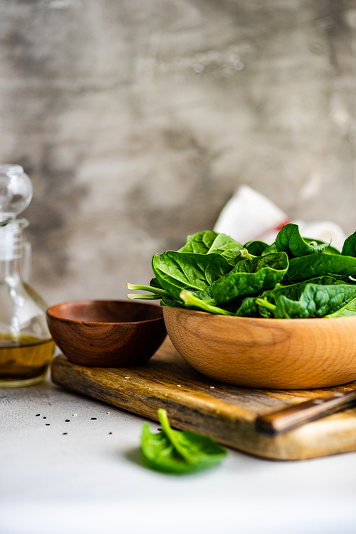 Organic food concept with fresh baby spinach leaves for healthy salad cooking