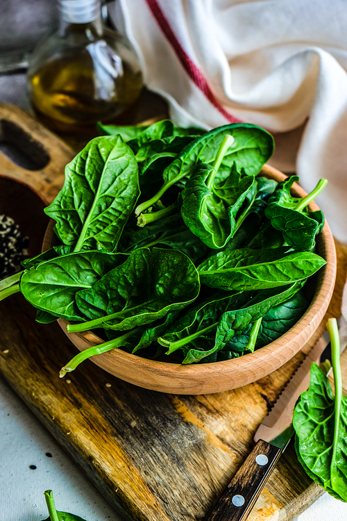 Organic food concept with fresh baby spinach leaves for healthy salad cooking