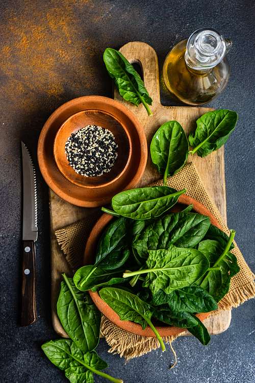 Organic food concept with fresh baby spinach leaves for healthy salad cooking