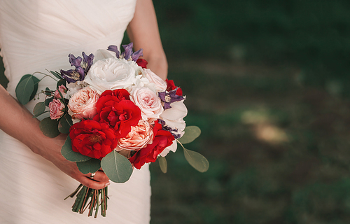 close up.wedding bouquet in the hands of the bride. holidays and traditions