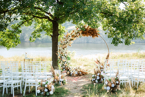 wedding ceremony area with dried flowers in a meadow in a green forest