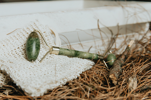 A jade roller over autumnal leaves mockup with copy space