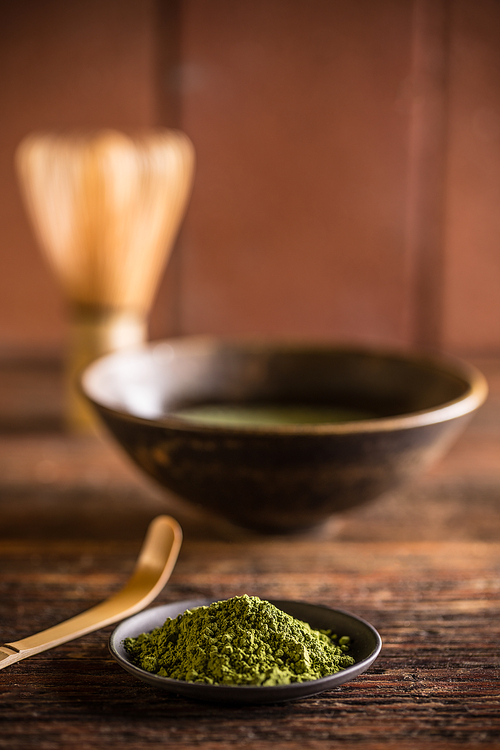 Matcha, powder green tea in black plate