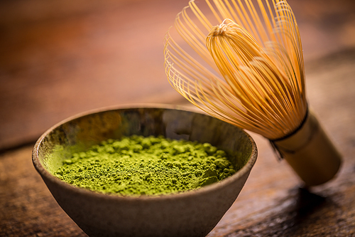 Matcha fine powdered green tea with bamboo whisk