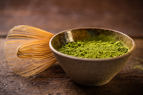 Green powder tea with bamboo whisk