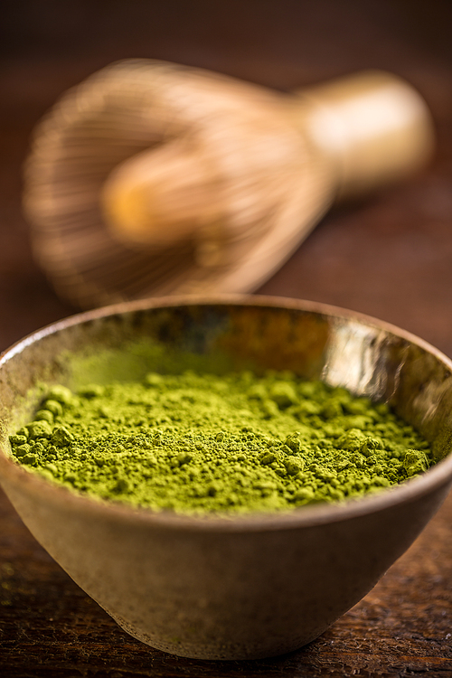 Powdered green matcha tea in bowl