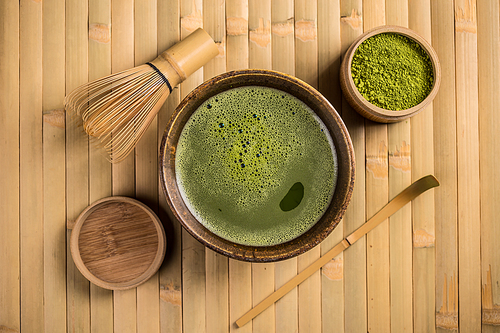 Matcha fine powdered green tea with whisk and spoon