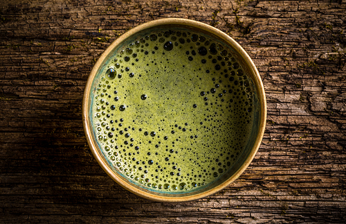 Top view of organic green matcha tea in a bowl