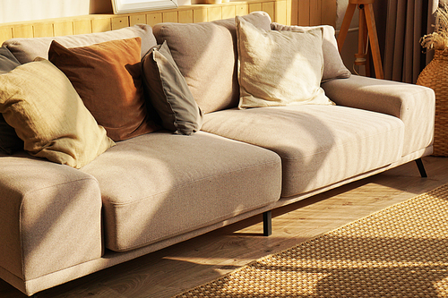 Designer sofa in scandinavian style at home, sunny day and light