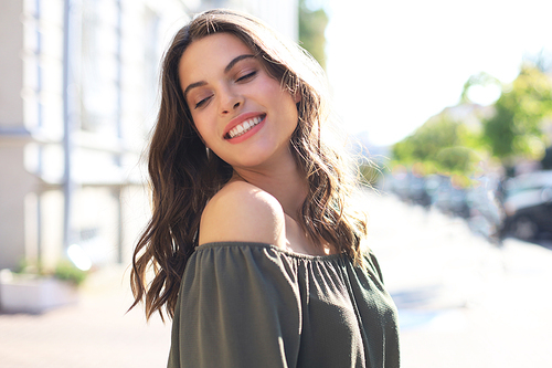 Smiling happy young beautiful woman walking outdoors