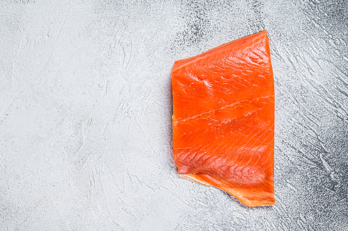 Smoked salmon fillet on a wooden table. White background. Top view. Copy space.