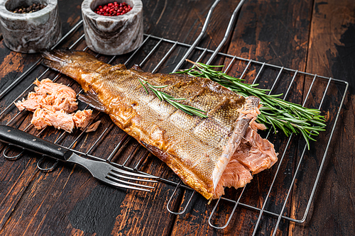 Salmon Hot smoked fish on a grill with herbs. Dark Wooden background. Top view.