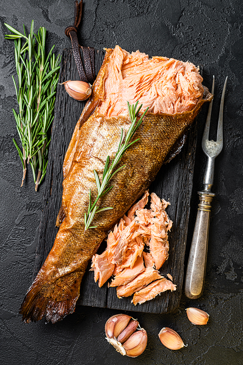 Salmon Hot smoked,  trout fish meat. Black background. Top view.