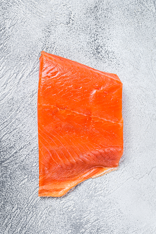 Smoked salmon fillet on a wooden table. White background. Top view.